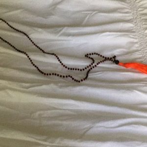 Long orange and black tassel necklace